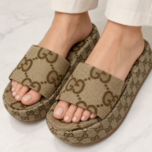 Model wearing beige monogram chunky slides
